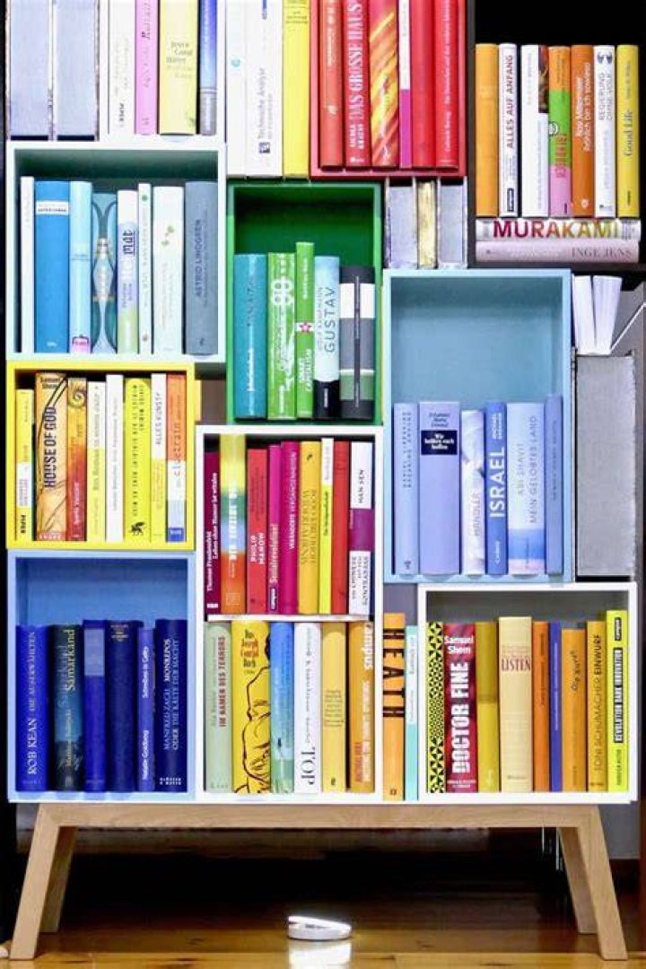Should books be stored flat or upright?